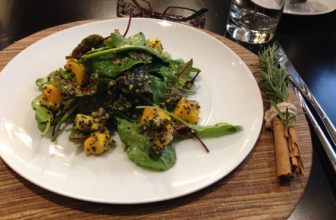 Bowls of spirulina, hemp seeds, moringa, nori and bee pollen arranged on a neutral kitchen surface